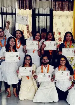 Graduates holding their certificates after the 200 hour yoga teacher training in Rishikesh